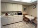 View of kitchen featuring microwave, dining table and tiled flooring at 12920 Wedgewood Way # A, Hudson, FL 34667
