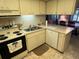 Functional kitchen featuring stainless steel sink and dishwasher with tiled floor at 12920 Wedgewood Way # A, Hudson, FL 34667