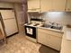 View of kitchen featuring refrigerator, stove and tiled flooring at 12920 Wedgewood Way # A, Hudson, FL 34667