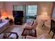 Comfortable living room featuring plush armchairs, glass coffee tables, and sliding door access at 12920 Wedgewood Way # A, Hudson, FL 34667
