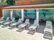 Community pool deck includes covered seating areas with tables and chairs, perfect for relaxing by the pool at 12920 Wedgewood Way # A, Hudson, FL 34667