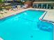 Large community pool with clear blue water, steps entry, and shaded lounging areas at 12920 Wedgewood Way # A, Hudson, FL 34667
