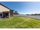 Large backyard with well-kept lawn, screened in patio, and white vinyl privacy fence at 13639 Ashlar Slate Pl, Riverview, FL 33579