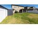 Large backyard featuring green grass, white vinyl fence, and plenty of space for outdoor activities at 13639 Ashlar Slate Pl, Riverview, FL 33579