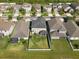 Aerial view of a backyard with lush green grass, white fence, covered patio, and manicured landscaping at 13639 Ashlar Slate Pl, Riverview, FL 33579