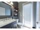 Bathroom features a vanity with a marble countertop, toilet, and shelves at 13639 Ashlar Slate Pl, Riverview, FL 33579