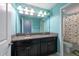 Bright bathroom with a double sink vanity, granite countertop, and dinosaur-themed shower curtain at 13639 Ashlar Slate Pl, Riverview, FL 33579