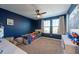 Playful bedroom with a twin bed, natural light, blue accent wall, and space for play at 13639 Ashlar Slate Pl, Riverview, FL 33579