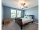 Bright bedroom with natural light and carpet, featuring a standard bed beneath a ceiling fan at 13639 Ashlar Slate Pl, Riverview, FL 33579