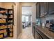 Walk-in pantry features dark cabinets, granite countertops, and plenty of storage space at 13639 Ashlar Slate Pl, Riverview, FL 33579