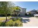 Eye-level shot of a two-story home with lush landscaping and attached two car garage at 13639 Ashlar Slate Pl, Riverview, FL 33579