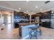 Spacious kitchen features dark wood cabinets, granite counters, stainless appliances, and a large center island at 13639 Ashlar Slate Pl, Riverview, FL 33579