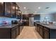 Spacious kitchen features dark cabinetry, granite countertops, stainless steel appliances, and tile flooring at 13639 Ashlar Slate Pl, Riverview, FL 33579