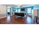 Living room with hardwood floors, ceiling fan, and plenty of natural light at 13639 Ashlar Slate Pl, Riverview, FL 33579