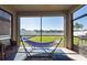 Screened patio with a hammock, comfortable seating, and a backyard view at 13639 Ashlar Slate Pl, Riverview, FL 33579