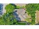 Birds-eye view of a well maintained roof and backyard surrounded by green trees and vegetation at 1518 Rolling Meadow Dr, Valrico, FL 33594