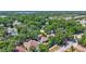 Aerial view showcases the property nestled within a lush, tree-filled neighborhood with a nearby lake at 1518 Rolling Meadow Dr, Valrico, FL 33594
