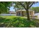 Well-manicured lawn and screened lanai for outdoor enjoyment, complemented by mature trees at 1518 Rolling Meadow Dr, Valrico, FL 33594