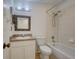 Well-lit bathroom features a shower-tub, framed mirror, and a single sink vanity at 1518 Rolling Meadow Dr, Valrico, FL 33594