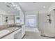 This spacious bathroom features dual sinks, a soaking tub and a glass enclosed shower at 1518 Rolling Meadow Dr, Valrico, FL 33594