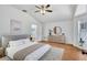 Vaulted ceiling bedroom featuring a ceiling fan, a comfortable bed, and a door to an en-suite bathroom at 1518 Rolling Meadow Dr, Valrico, FL 33594