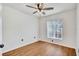 This bedroom has a ceiling fan, wood floor, and large window for natural light at 1518 Rolling Meadow Dr, Valrico, FL 33594