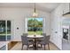 Bright breakfast nook featuring a round table, four chairs, and a sliding glass door to the backyard at 1518 Rolling Meadow Dr, Valrico, FL 33594