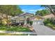 Inviting single-Gathering home with lush lawn, manicured shrubs, and a two-car garage at 1518 Rolling Meadow Dr, Valrico, FL 33594
