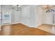 Spacious foyer with wood floors, complemented by an elegant chandelier and neutral walls at 1518 Rolling Meadow Dr, Valrico, FL 33594