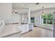 White kitchen features stainless steel appliances, a peninsula with sink, and natural light at 1518 Rolling Meadow Dr, Valrico, FL 33594