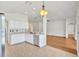 Eat-in kitchen with stainless steel appliances, white cabinetry, and tile flooring at 1518 Rolling Meadow Dr, Valrico, FL 33594