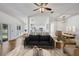 Open-concept living space with modern furnishings, a ceiling fan, and abundant natural light at 1518 Rolling Meadow Dr, Valrico, FL 33594