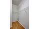 A small, walk-in closet featuring metal shelves and hardwood flooring at 1518 Rolling Meadow Dr, Valrico, FL 33594