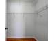 Spacious walk-in closet equipped with metal shelving and wood flooring at 1518 Rolling Meadow Dr, Valrico, FL 33594