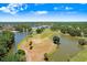 An aerial view capturing a scenic golf course community with serene lakes and beautifully landscaped surroundings at 16118 Lytham Dr, Odessa, FL 33556