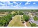Aerial view of a picturesque golf course community with lush landscaping, serene lakes, and well-manicured fairways at 16118 Lytham Dr, Odessa, FL 33556