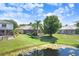 View of the backyard showing the pond and luscious lawn at 16118 Lytham Dr, Odessa, FL 33556