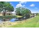 Scenic backyard view of a tranquil canal, bordered by lush greenery and a well-maintained lawn at 16118 Lytham Dr, Odessa, FL 33556