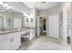 Spacious bathroom with dual sinks, vanity area, and tiled flooring at 16118 Lytham Dr, Odessa, FL 33556