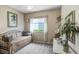 Cozy bedroom with a daybed, neutral carpeting, and ample natural light from the window at 16118 Lytham Dr, Odessa, FL 33556