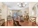 Dining room with hardwood floors, chandelier, and views of the living room at 16118 Lytham Dr, Odessa, FL 33556