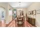 Formal dining room featuring wood floors, natural light, and stylish chandelier at 16118 Lytham Dr, Odessa, FL 33556