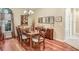Dining room features a wood table set, hardwood floors, and natural light at 16118 Lytham Dr, Odessa, FL 33556