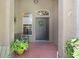 Welcoming front porch with brick flooring, bench and beautiful decorative windows at 16118 Lytham Dr, Odessa, FL 33556