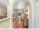 Elegant hallway with hardwood floors leading to the open-concept living area at 16118 Lytham Dr, Odessa, FL 33556