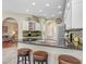 Open kitchen with granite counters, an island with seating and modern appliances at 16118 Lytham Dr, Odessa, FL 33556