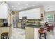 Modern kitchen featuring stainless steel appliances, granite countertops, and ample cabinet space at 16118 Lytham Dr, Odessa, FL 33556