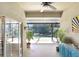 Covered lanai with access to the pool, featuring tile flooring, ceiling fan, and lush landscaping at 16118 Lytham Dr, Odessa, FL 33556