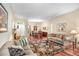 Inviting living room with plush seating, hardwood floors, and a seamless flow into the dining area at 16118 Lytham Dr, Odessa, FL 33556