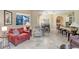 Open-concept living room with tile floors, neutral walls, and view of the dining and kitchen areas at 16118 Lytham Dr, Odessa, FL 33556